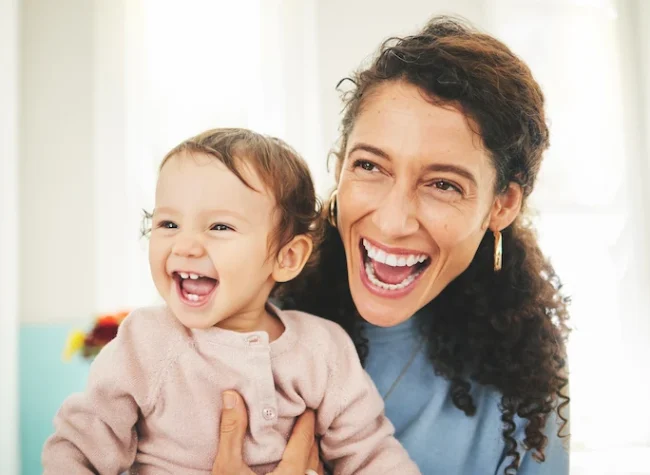 laughing-adult-holds-smiling-infant-indoors-2026-01-09-11-01-19-utc